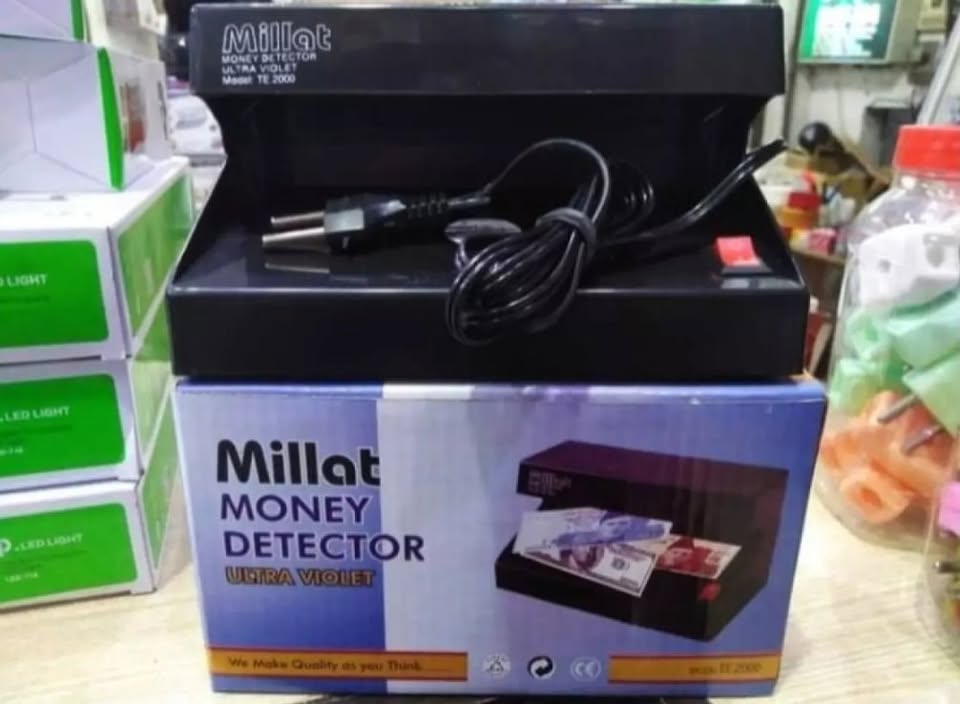 Black UV money detector with a Pakistani currency note on a white background, featuring Raza Gadgets logo.