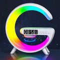 Colorful moon-shaped clock with digital display on a dark background