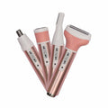 Set of pink and white hair removal devices on a white background