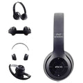Black wireless headphones with various attachments on a white background