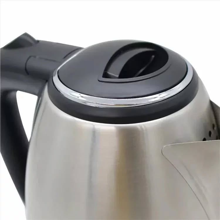 Close-up of a stainless steel kettle with black handle on a white background